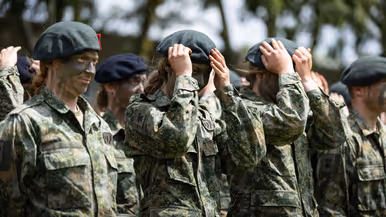 Militairen zetten hun baretten op.