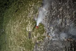 Een bambi bucket hangt onder een Chinook.