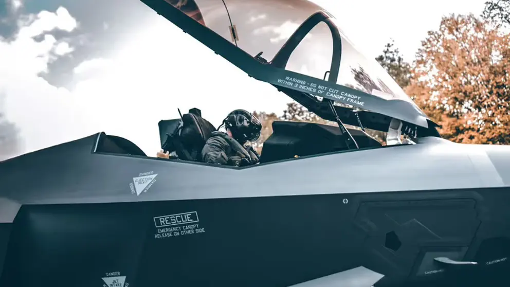 Pilot in F-35 met cockpit open.
