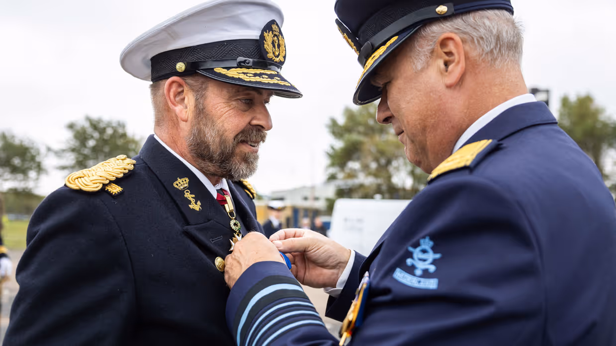 Tas krijgt het ereteken opgespeld door Onno Eichelsheim. 