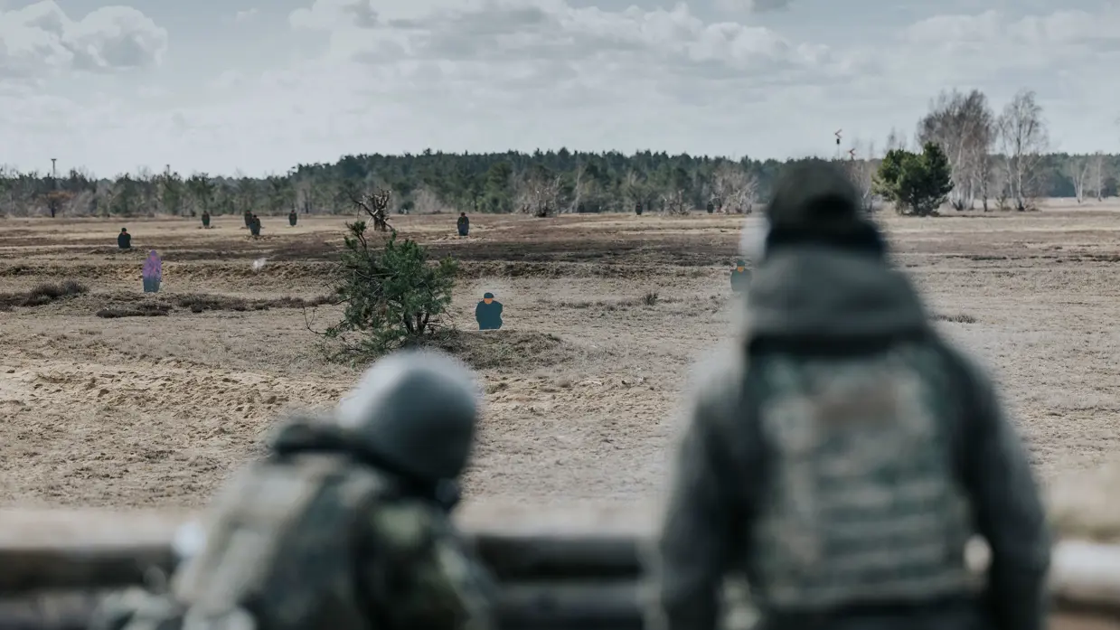 Oekraïners schieten vanuit loopgraaf, militair richt op klapschijven, Oekraïners liggen achter mitrailleur