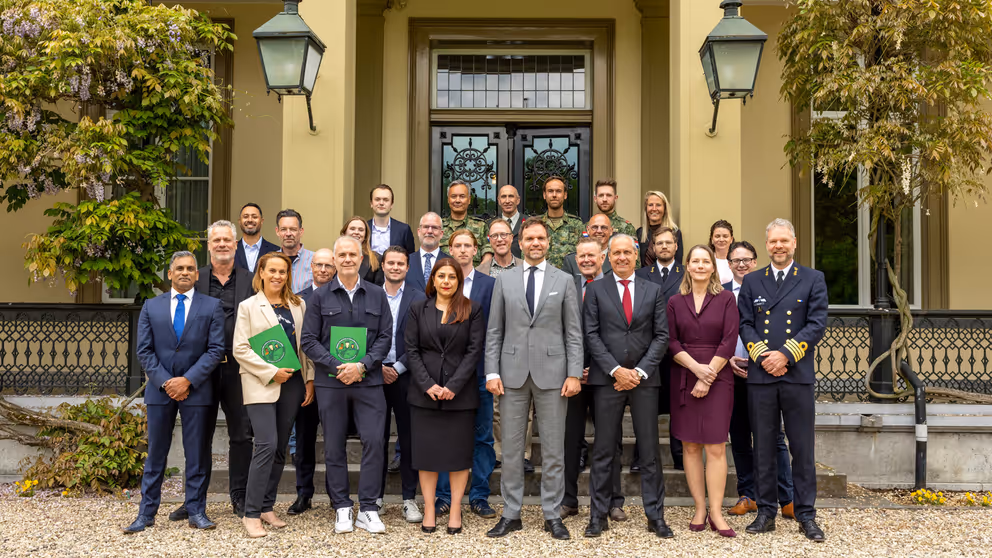 Groepsfoto van de staatssecretaris met werkgevers en reservisten.