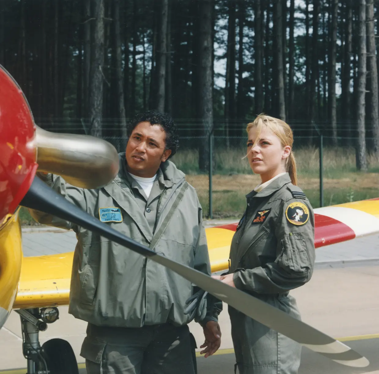 Eerste-luitenant in gesprek met onderhoudsmonteur bij een Pilatus PC-7 lesvliegtuig.