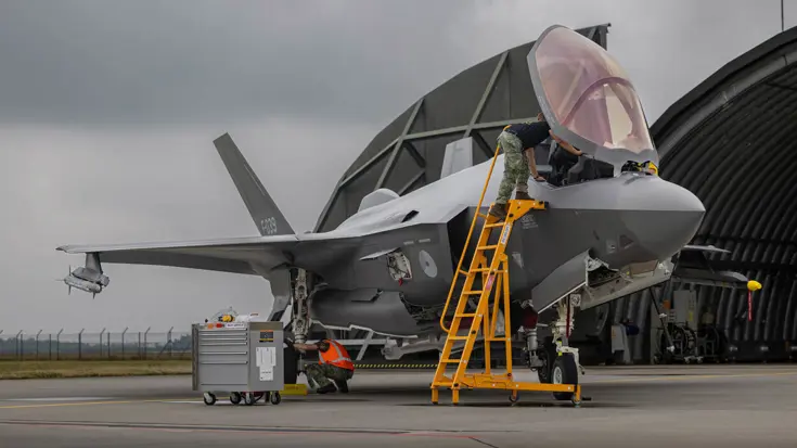 Militair staat op ladder tegen cockpit F-35.