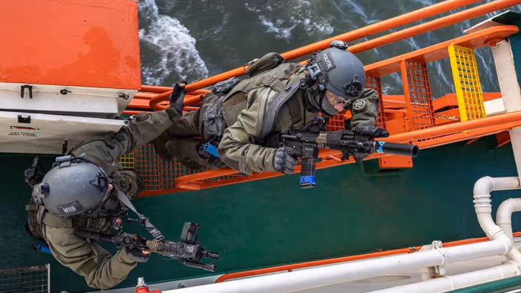 2 gehelmde mannen beklimmen stalen trap.