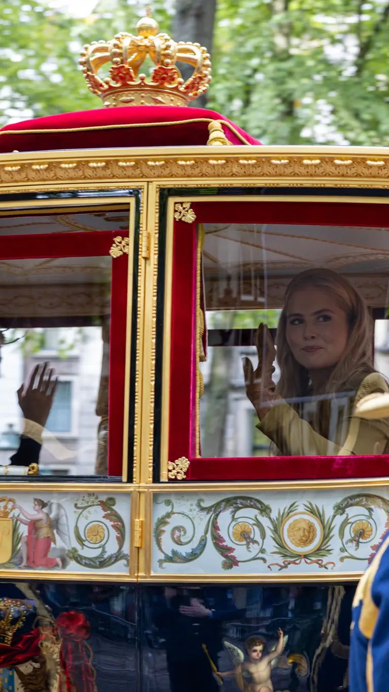 Prinses Amalia en Koning Willem-Alexander zwaaien vanuit de koets op Prinsjesdag 