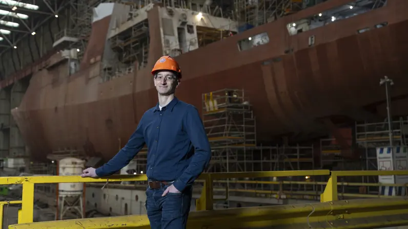 Floris Fortgens, projectleider groot onderhoud, staat op de werf voor Zr.Ms. Holland tijdens onderhoudswerkzaamheden. 