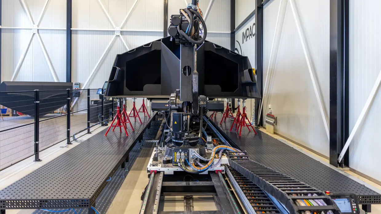 De romp van een 3D-geprinte boot op een werkbank.