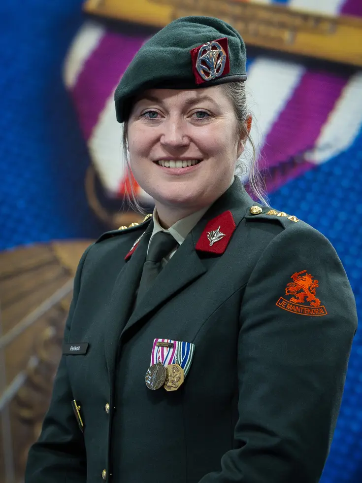 Vriendelijk kijkende militair met baret op en medailles op haar tenue.