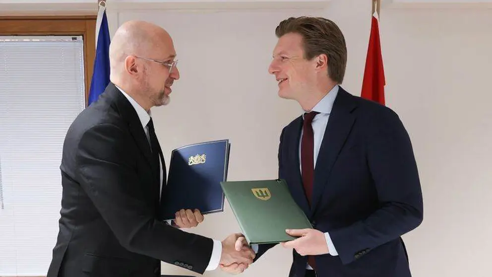 De defensieministers van Oekraine en Nederland schudden elkaar de hand.