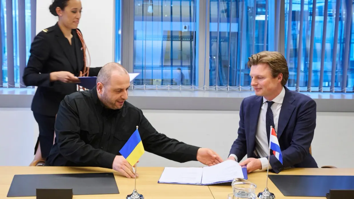 Minister Ruben Brekelmans (rechts) en zijn Oekraiense collega aan een tafel.