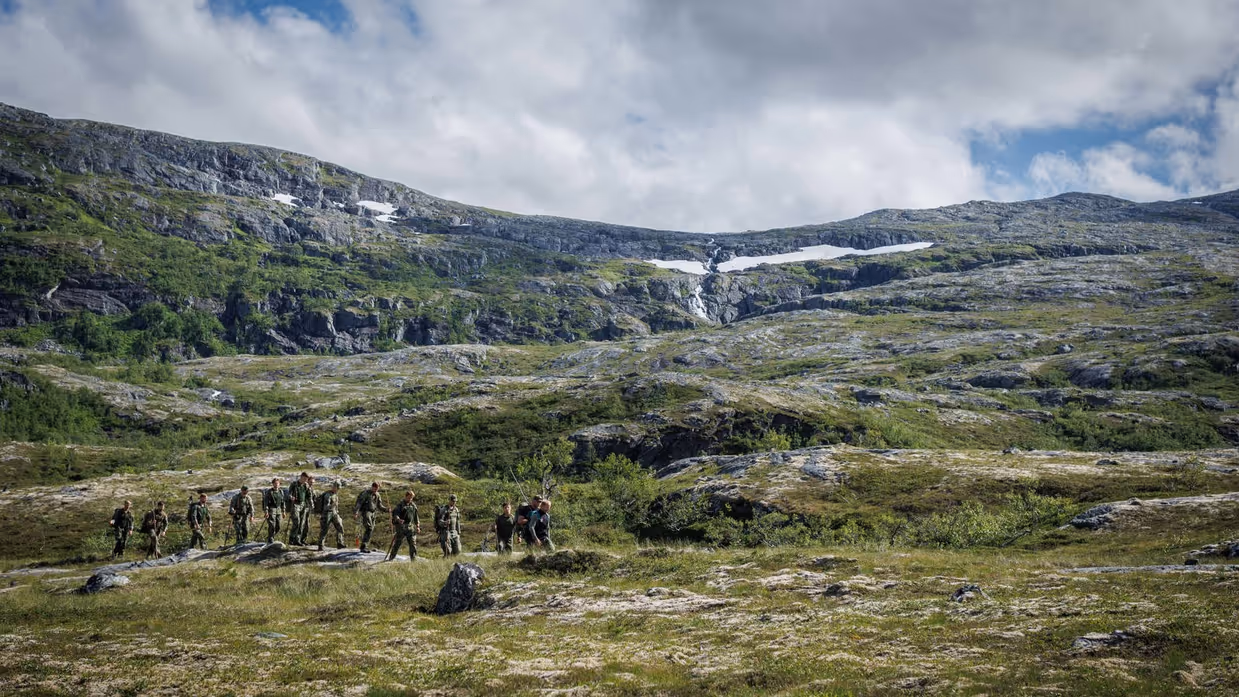 Peloton van militairen dat door Noorweegse landschap trekt.