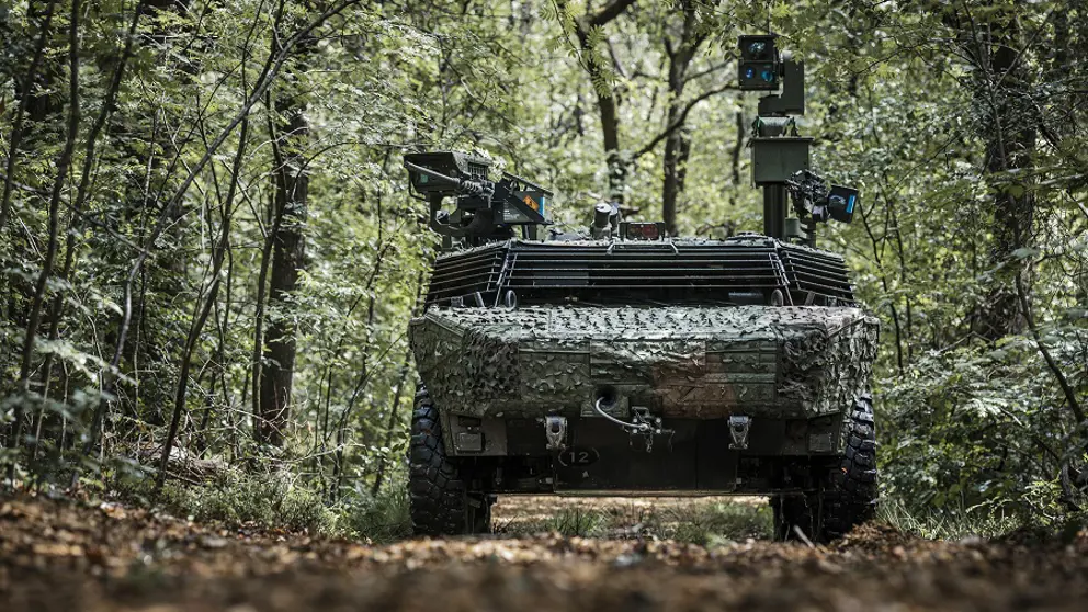 Gecamoufleerd militair voertuig rijdt door een bos