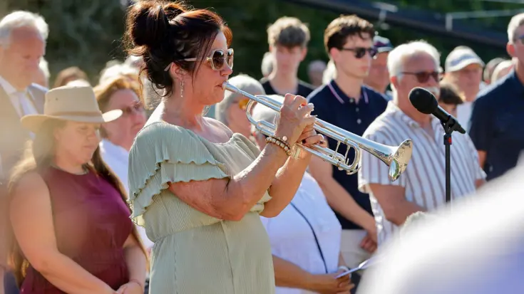 Een vrouw speelt op een trompet.