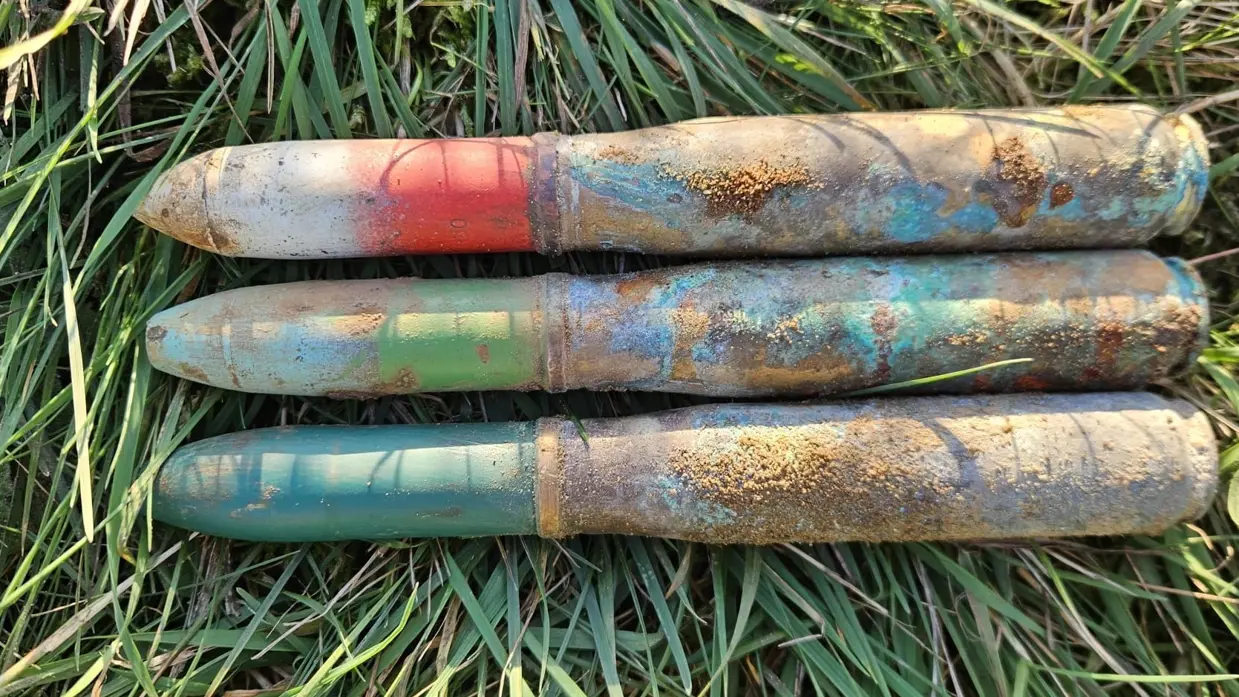 3 granaten naast elkaar in het gras.