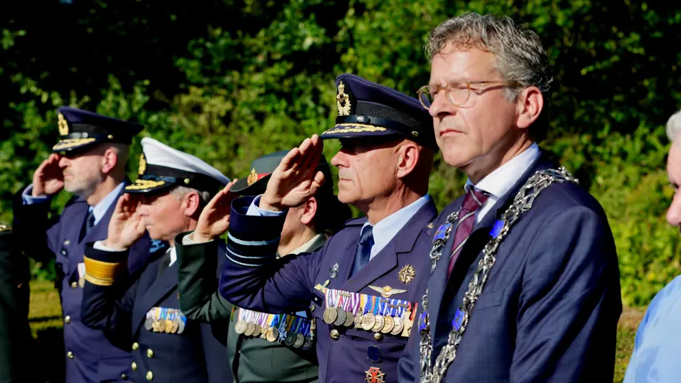 Militairen die salueren en de burgemeester van Eindhoven. 