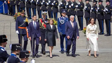 Minister-president Rob Jetten loopt samen met de bondspresident van Duitsland, diens vrouw en de burgemeester van Amsterdam door een erehaag van militairen gekleed in ceremonieel tenue. Vlak achter hen lopen ook drie militairen in ceremonieel tenue.