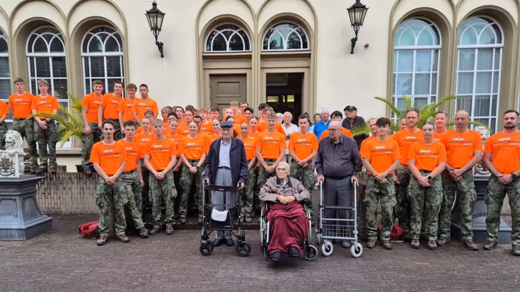 Studenten poseren met veteranen.